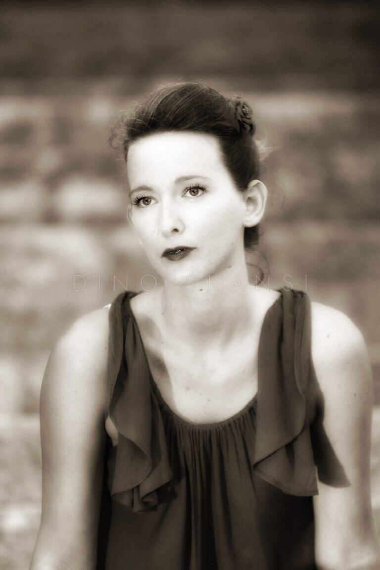 Sepia-toned portrait of a woman with short hair in a sleeveless top
