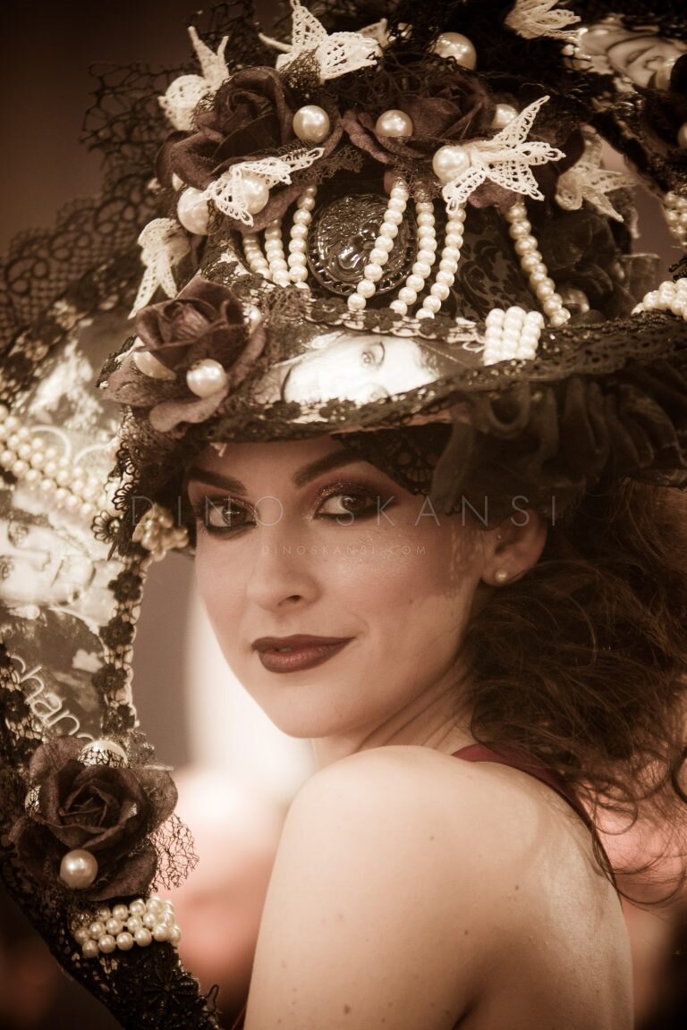 Sepia-toned portrait of a woman in a flower-decorated hat
