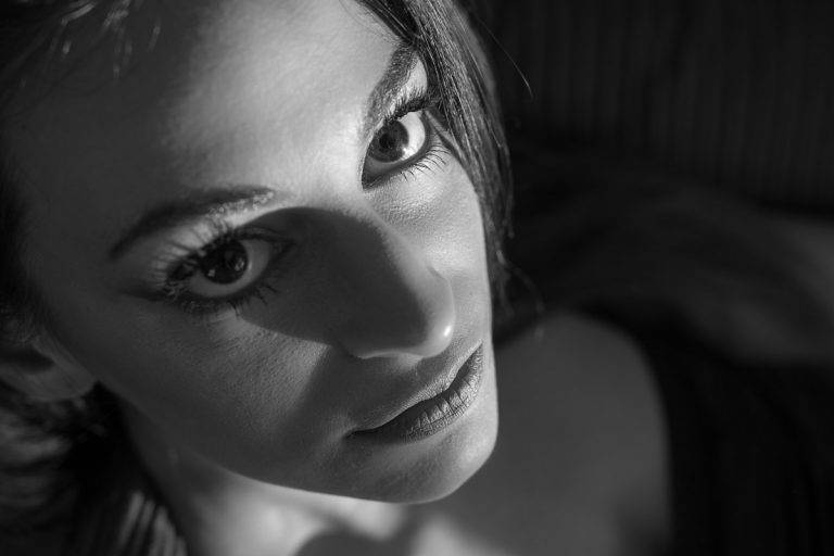 Black and white close-up of a woman looking up at the camera