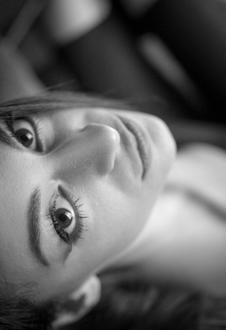 Black and white close-up of a woman's face as she lies on her side