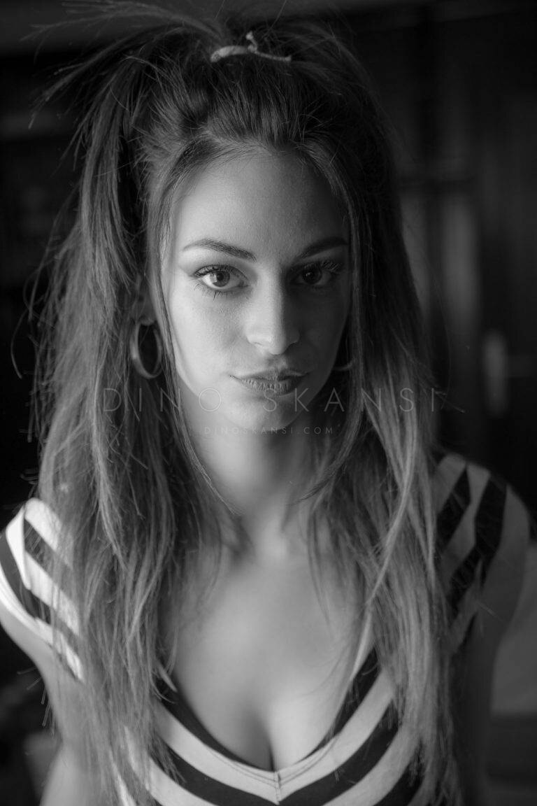 Black and white portrait of a woman with long hair in a striped top