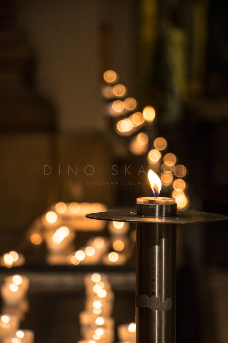 Lit candles glowing in a dark interior