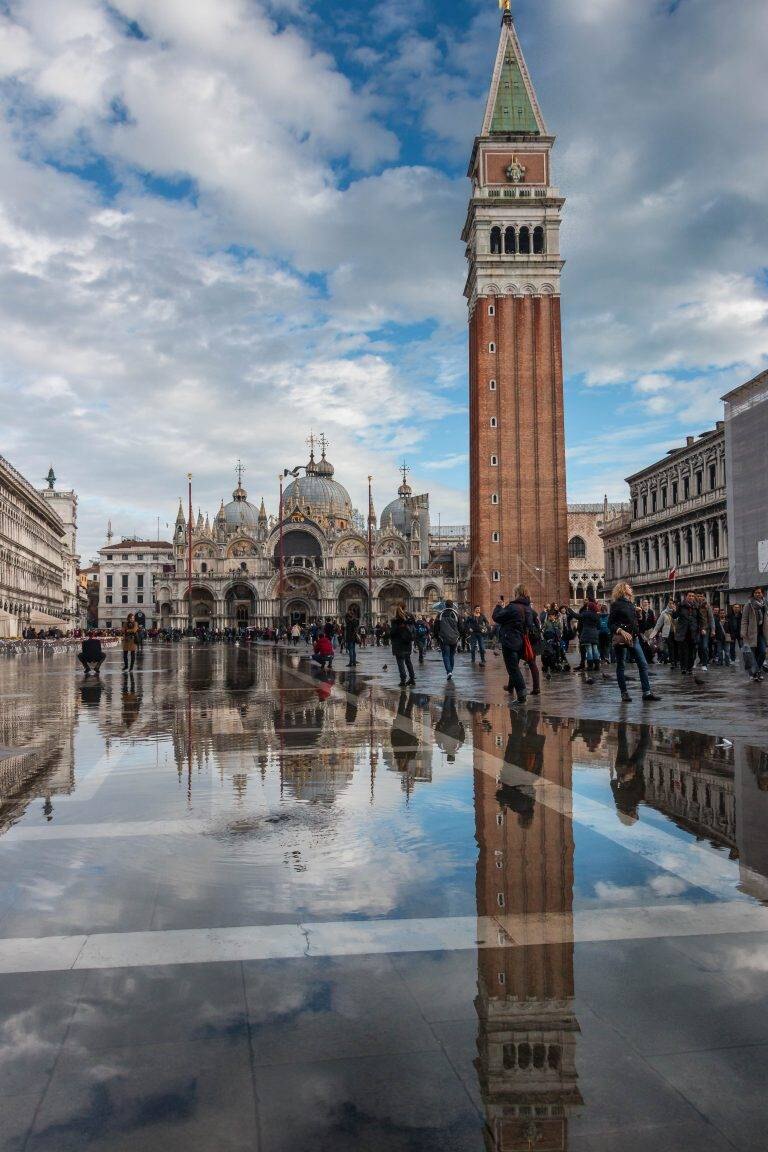 St Mark's Square with the campanile reflected in floodwater, Venice