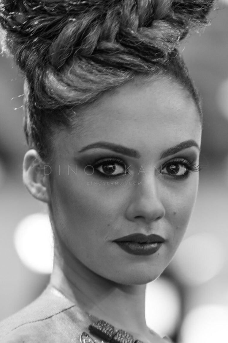 Black and white portrait of a woman with an updo and strong eye make-up