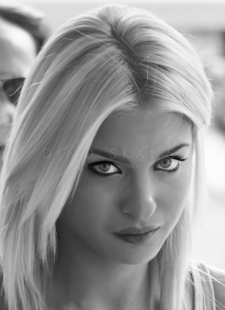 Black and white portrait of a woman with long blonde hair looking up