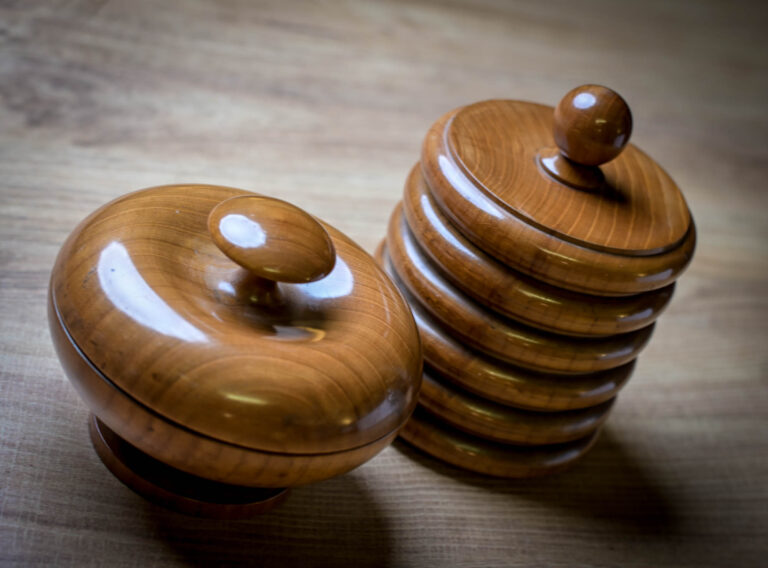 Close-up of two carved wooden lidded boxes