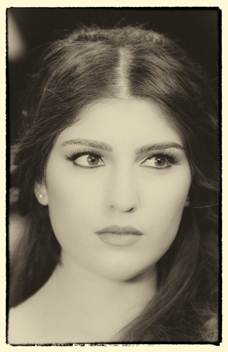 Sepia-toned portrait of a woman with long dark hair looking into the camera