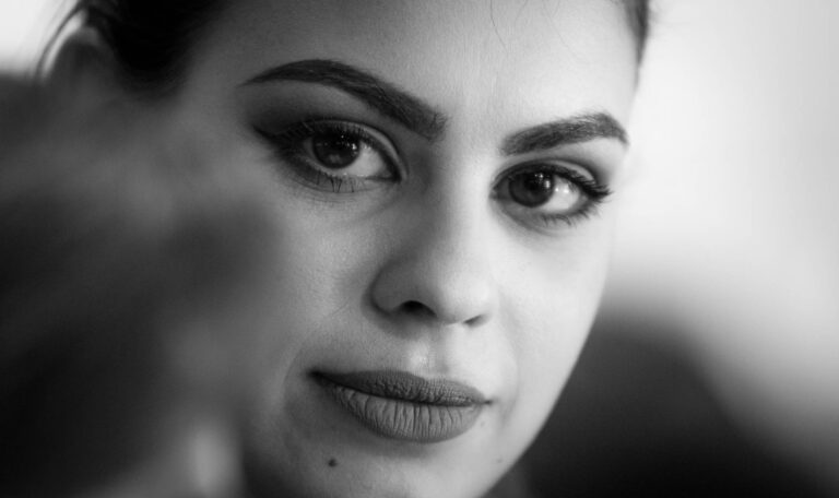 Black and white close-up of a woman's face with defined eyebrows