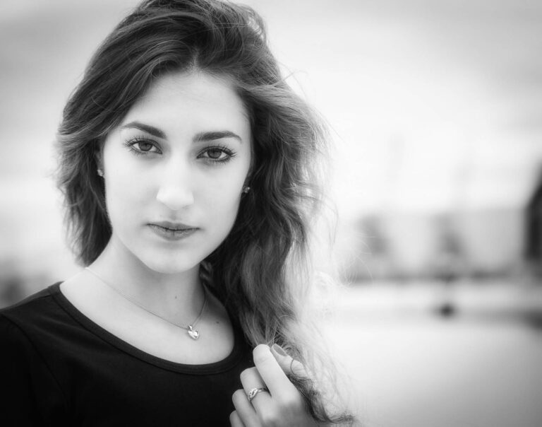 Black and white portrait of a woman with long dark hair in a black top