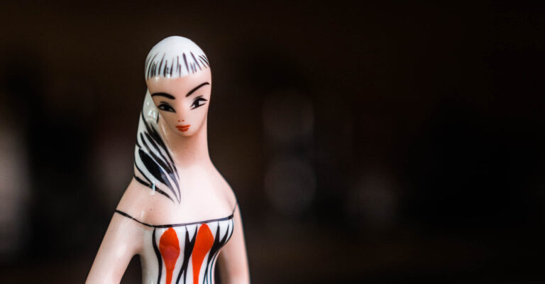 Close-up of the painted face of a ceramic figurine