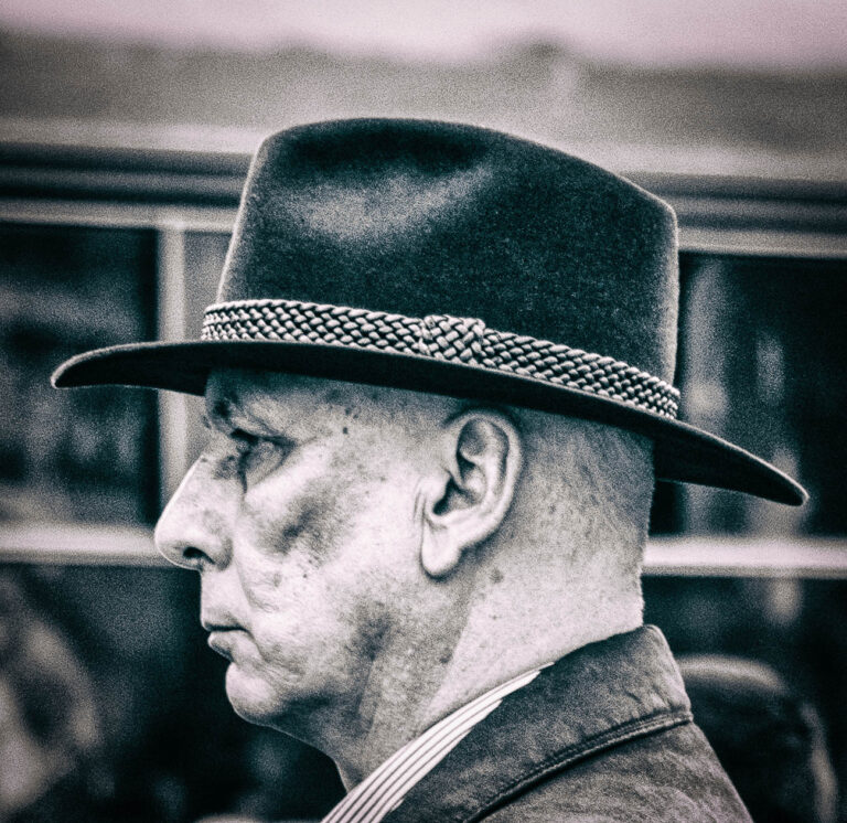 Colour profile portrait of an elderly man in a wide-brimmed hat
